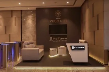 A modern office lobby featuring comfortable couch, designed by Flipspaces